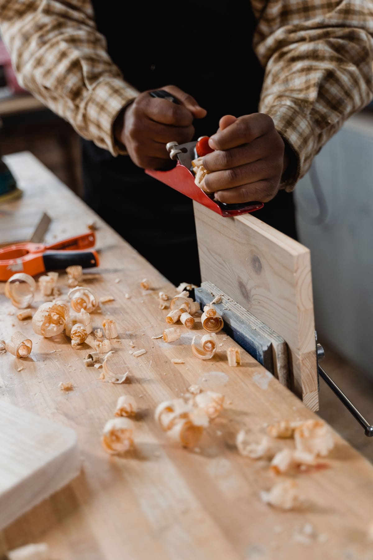 Hands working timber at the bench